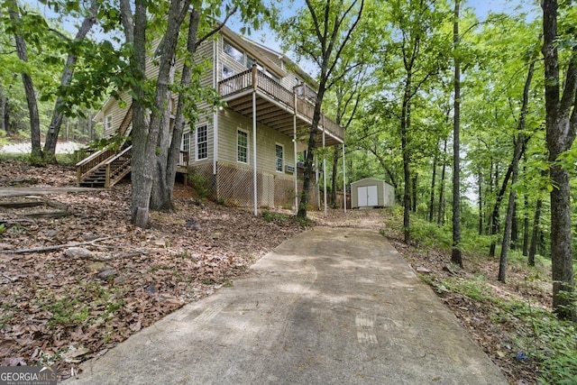 15635 US Highway 27 N, Hamilton, GA 31811 - exterior space with driveway, a deck, an outdoor structure, a storage unit, and stairs