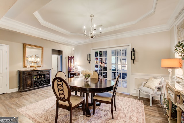 51 Norton Ave, Acworth, GA 30101 - dining space featuring a chandelier, a raised ceiling, french doors, wood finished floors, and ornamental molding