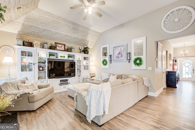 51 Norton Ave, Acworth, GA 30101 - living room featuring light wood-style floors, ceiling fan, vaulted ceiling, baseboards, and a chandelier