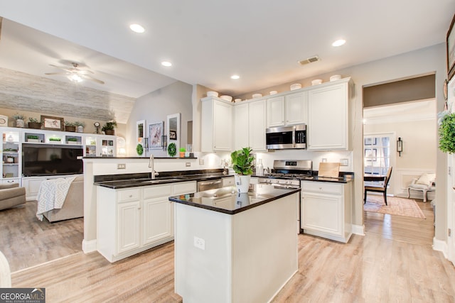 51 Norton Ave, Acworth, GA 30101 - kitchen with stainless steel appliances, a sink, open floor plan, a peninsula, and white cabinetry
