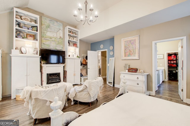 51 Norton Ave, Acworth, GA 30101 - bedroom featuring a chandelier, wood finished floors, a fireplace, baseboards, and lofted ceiling