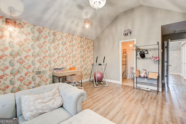 sitting room with wood finished floors, baseboards, and high vaulted ceiling