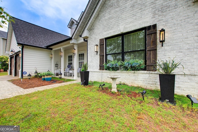 51 Norton Ave, Acworth, GA 30101 - view of front of house featuring an attached garage, driveway, brick siding, and roof with shingles