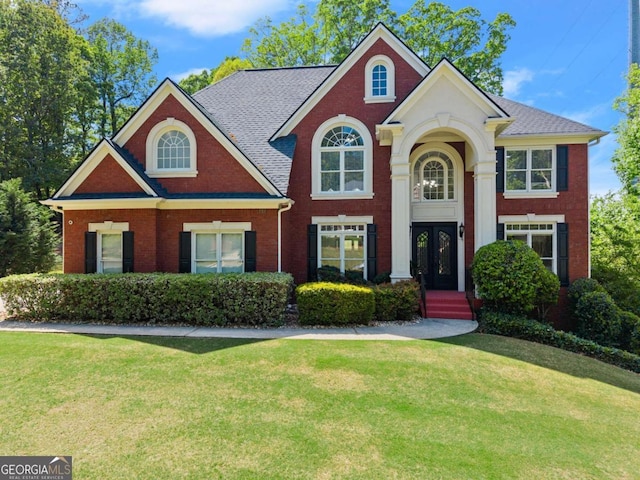1900 Chattahoochee Run Dr, Suwanee, GA 30024 - view of front of home featuring a front lawn, brick siding, and french doors