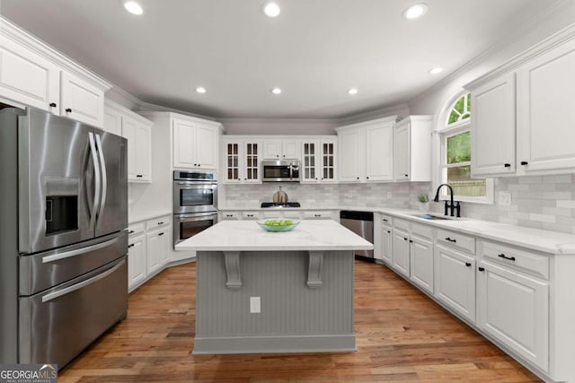 kitchen with a sink, white cabinetry, and appliances with stainless steel finishes