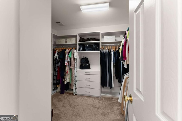 spacious closet with light carpet and visible vents
