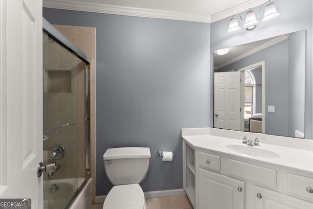 bathroom featuring crown molding, vanity, toilet, baseboards, and bath / shower combo with glass door