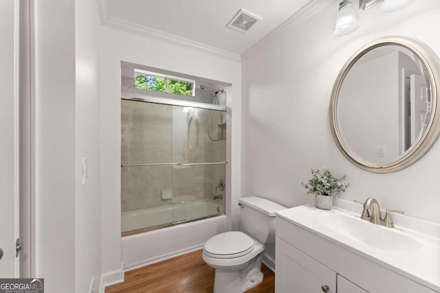 bathroom with visible vents, wood finished floors, vanity, toilet, and ornamental molding