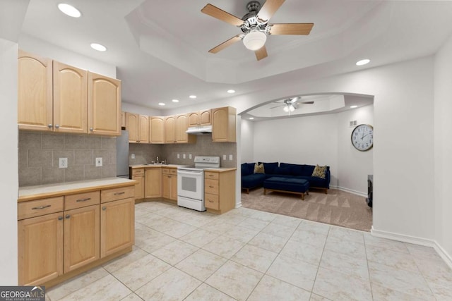 kitchen with light brown cabinets, white range with electric stovetop, under cabinet range hood, and ceiling fan