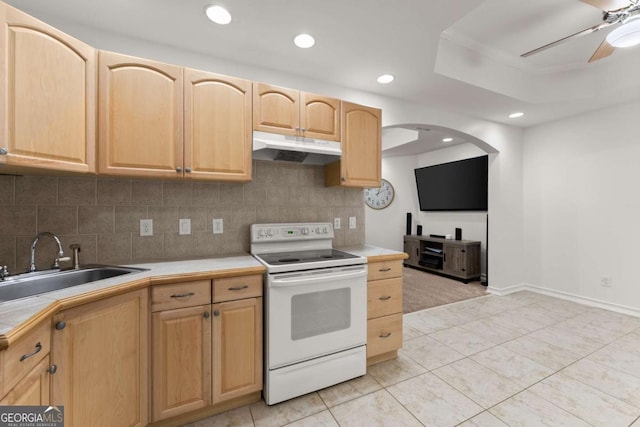 kitchen featuring light brown cabinetry, white range with electric stovetop, ceiling fan, a sink, and under cabinet range hood