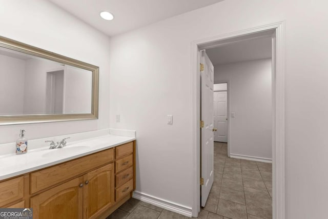 bathroom with recessed lighting, baseboards, tile patterned flooring, and vanity