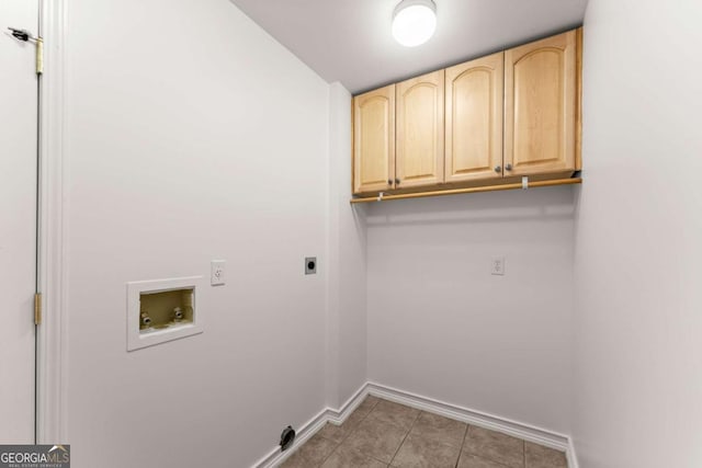 clothes washing area featuring hookup for an electric dryer, cabinet space, light tile patterned floors, baseboards, and hookup for a washing machine