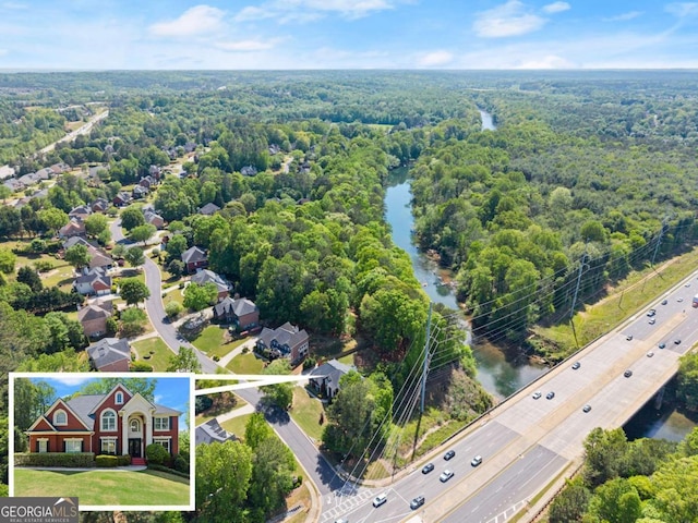 bird's eye view featuring a water view and a wooded view