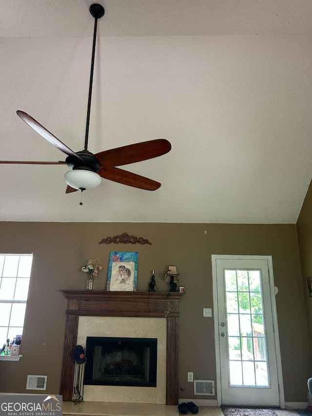 interior details with visible vents, a ceiling fan, and a premium fireplace