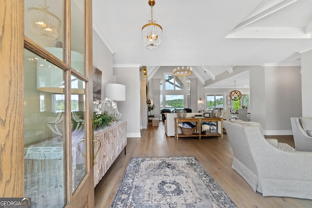 239 Lakeshore Cir, Milledgeville, GA 31061 - foyer with an inviting chandelier, wood finished floors, vaulted ceiling with beams, and baseboards