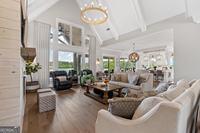 239 Lakeshore Cir, Milledgeville, GA 31061 - living room with visible vents, hardwood / wood-style floors, an inviting chandelier, beam ceiling, and high vaulted ceiling