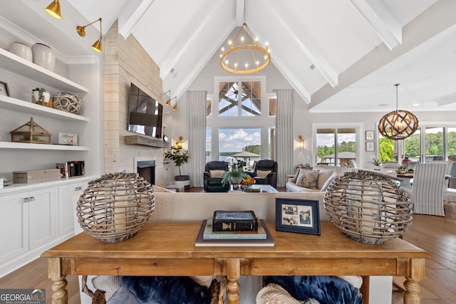 239 Lakeshore Cir, Milledgeville, GA 31061 - living area featuring hardwood / wood-style flooring, a fireplace, beam ceiling, high vaulted ceiling, and a notable chandelier