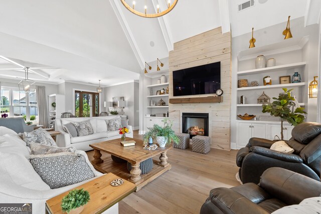 239 Lakeshore Cir, Milledgeville, GA 31061 - living area with a large fireplace, beam ceiling, light wood-style floors, built in features, and visible vents
