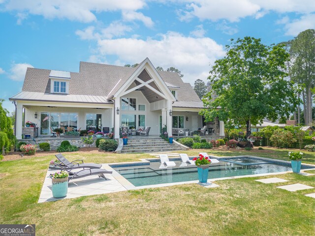 239 Lakeshore Cir, Milledgeville, GA 31061 - back of property with a standing seam roof, metal roof, and a patio