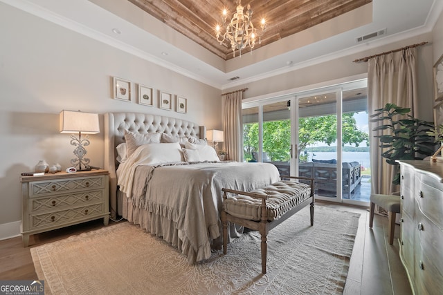 239 Lakeshore Cir, Milledgeville, GA 31061 - bedroom with a notable chandelier, a raised ceiling, access to exterior, visible vents, and ornamental molding