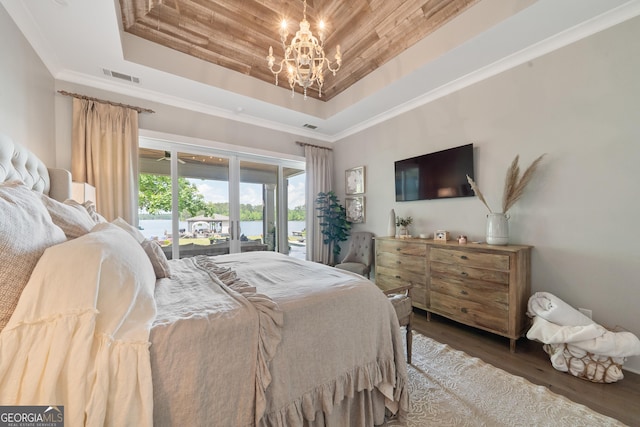 239 Lakeshore Cir, Milledgeville, GA 31061 - bedroom with a notable chandelier, access to outside, a tray ceiling, visible vents, and wood finished floors