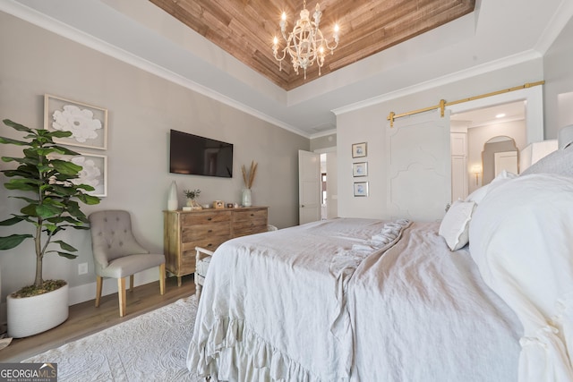 239 Lakeshore Cir, Milledgeville, GA 31061 - bedroom featuring an inviting chandelier, ornamental molding, wood finished floors, and a tray ceiling