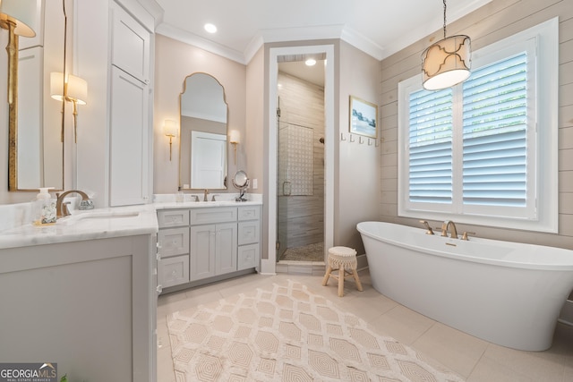 239 Lakeshore Cir, Milledgeville, GA 31061 - full bath with tile patterned floors, a shower stall, vanity, a soaking tub, and crown molding