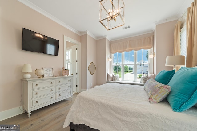 239 Lakeshore Cir, Milledgeville, GA 31061 - bedroom with an inviting chandelier, light wood-type flooring, baseboards, visible vents, and crown molding