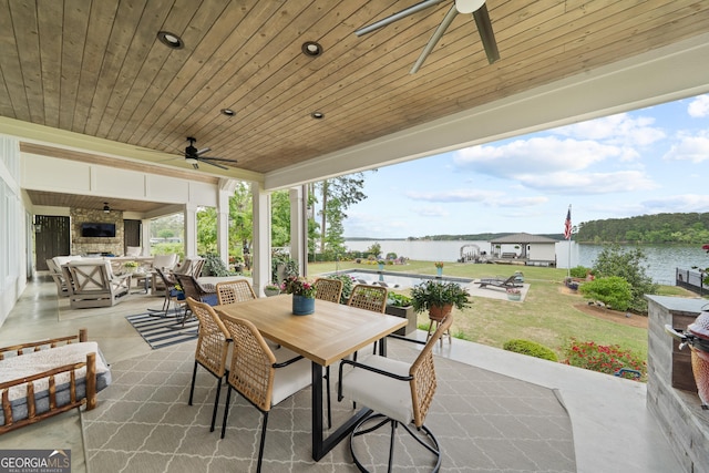 239 Lakeshore Cir, Milledgeville, GA 31061 - view of patio / terrace with an outdoor living space with a fireplace, a ceiling fan, a water view, and outdoor dining area