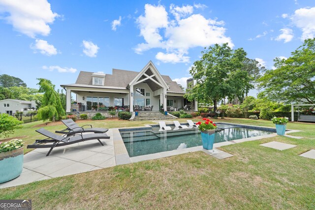 239 Lakeshore Cir, Milledgeville, GA 31061 - rear view of property with an outdoor pool, a yard, and a patio area