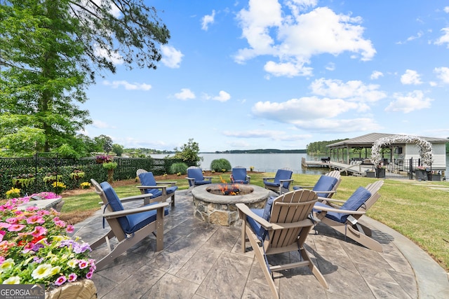 239 Lakeshore Cir, Milledgeville, GA 31061 - view of patio with a fire pit, fence, and a water view