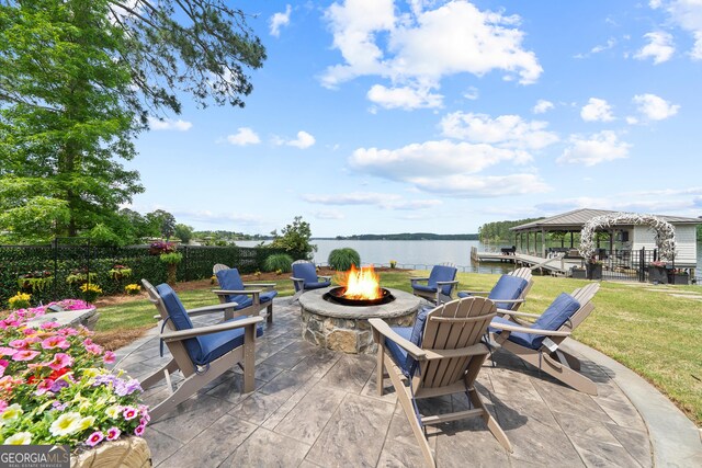 239 Lakeshore Cir, Milledgeville, GA 31061 - view of patio / terrace with fence, an outdoor fire pit, and a water view