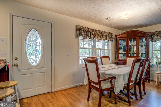 2000 Campbell Rd, Covington, GA 30014 - dining area with plenty of natural light, light wood finished floors, and a textured ceiling