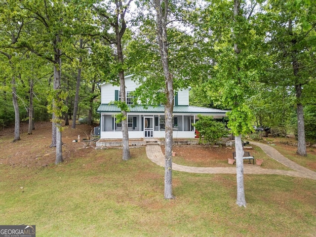 2000 Campbell Rd, Covington, GA 30014 - view of front of property featuring a sunroom, a front yard, and a metal roof