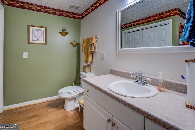 2000 Campbell Rd, Covington, GA 30014 - bathroom featuring vanity, wood finished floors, and a textured ceiling