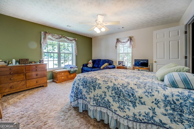 2000 Campbell Rd, Covington, GA 30014 - carpeted bedroom featuring multiple windows, ceiling fan, and a textured ceiling