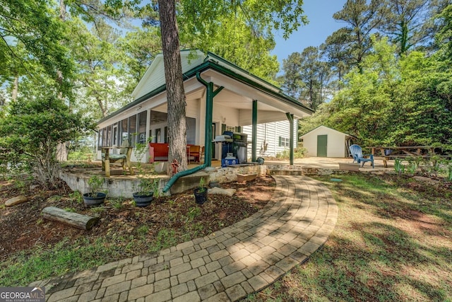 2000 Campbell Rd, Covington, GA 30014 - rear view of house with a shed, a sunroom, and a patio area
