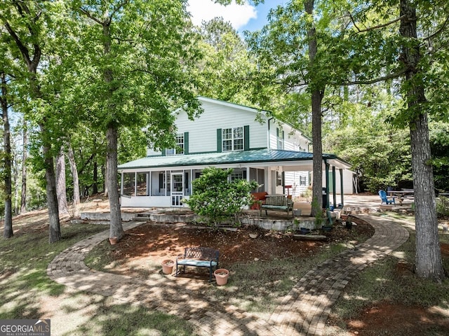 2000 Campbell Rd, Covington, GA 30014 - view of front of property with covered porch, a metal roof, and view of scattered trees