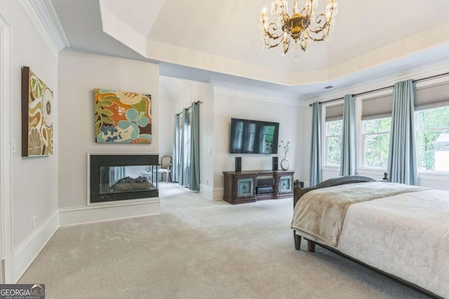 carpeted bedroom with crown molding, a multi sided fireplace, a raised ceiling, a chandelier, and baseboards