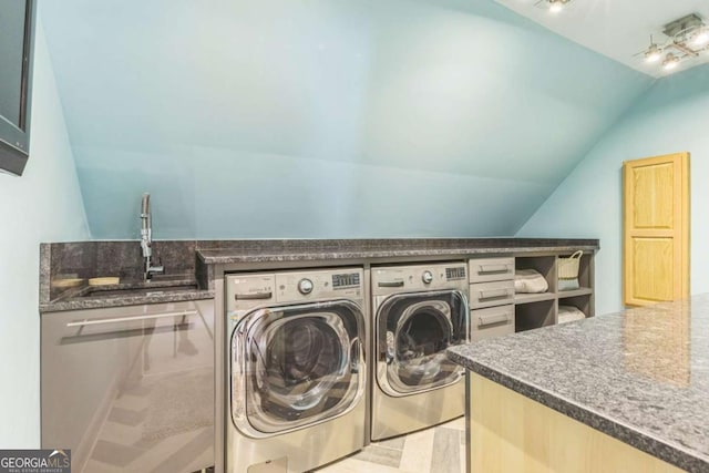 washroom featuring independent washer and dryer, laundry area, and a sink