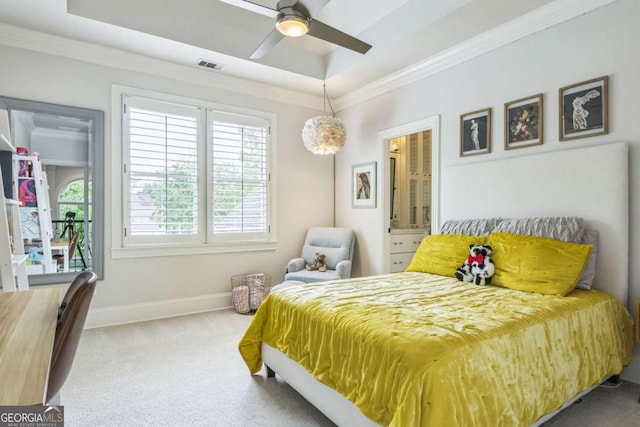 carpeted bedroom with ornamental molding, visible vents, a tray ceiling, and baseboards