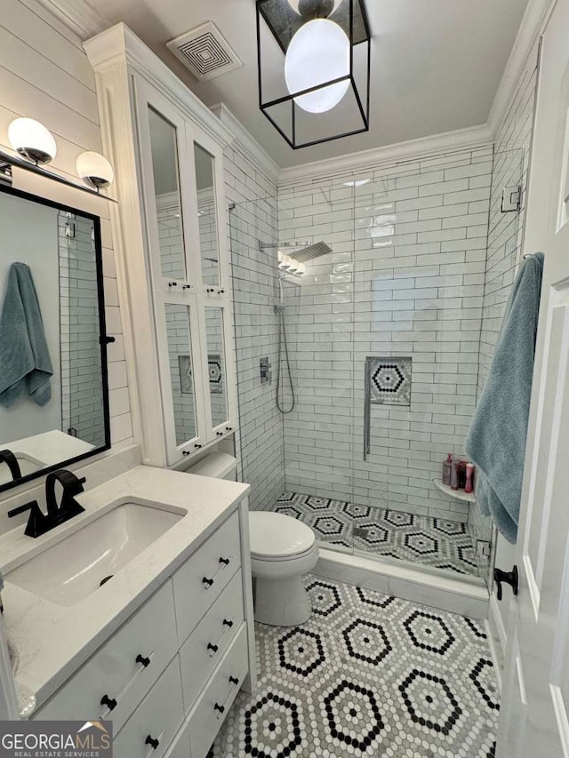full bath with toilet, visible vents, a shower stall, and vanity