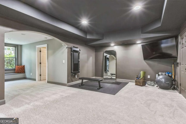 workout area with recessed lighting, arched walkways, carpet floors, and baseboards