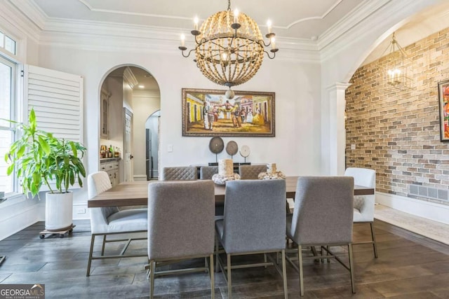 dining area featuring brick wall, a notable chandelier, dark wood-style floors, and arched walkways