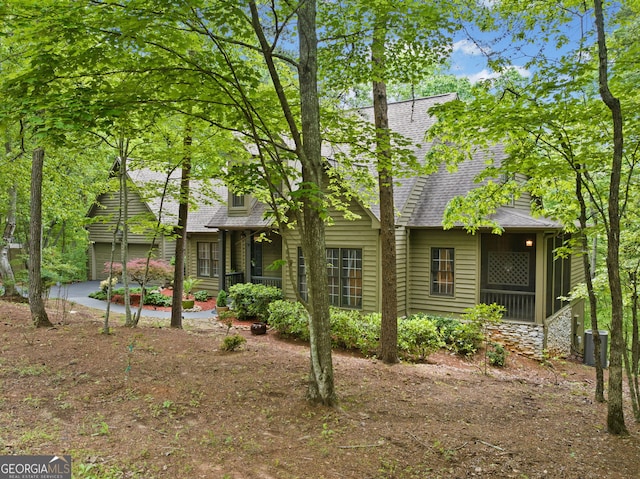 122 Woodstream Pt, Big Canoe, GA 30143 - rear view of property with a sunroom, a shingled roof, and cooling unit