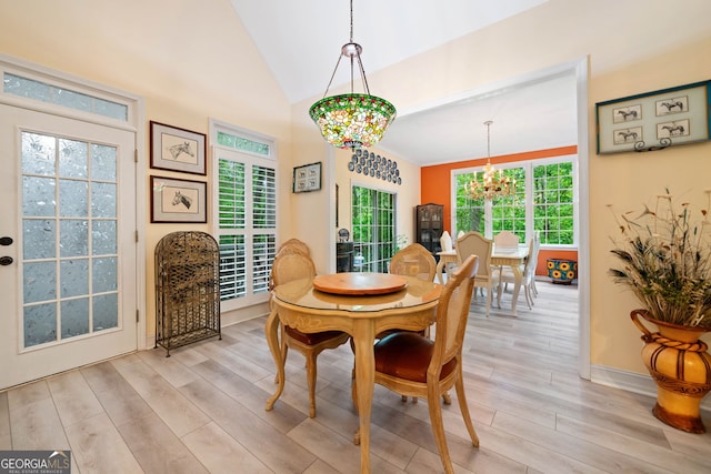 122 Woodstream Pt, Big Canoe, GA 30143 - dining area with baseboards, a chandelier, vaulted ceiling, and light wood-type flooring