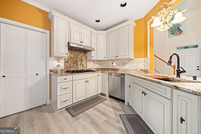 122 Woodstream Pt, Big Canoe, GA 30143 - kitchen featuring tasteful backsplash, stainless steel dishwasher, light wood-type flooring, a sink, and under cabinet range hood