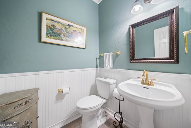 122 Woodstream Pt, Big Canoe, GA 30143 - half bathroom featuring wood finished floors, a sink, a wainscoted wall, and toilet