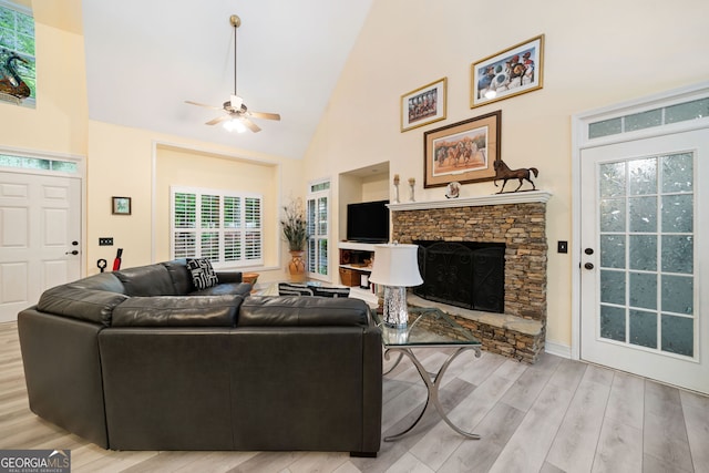 122 Woodstream Pt, Big Canoe, GA 30143 - living room featuring a ceiling fan, high vaulted ceiling, a stone fireplace, and wood finished floors