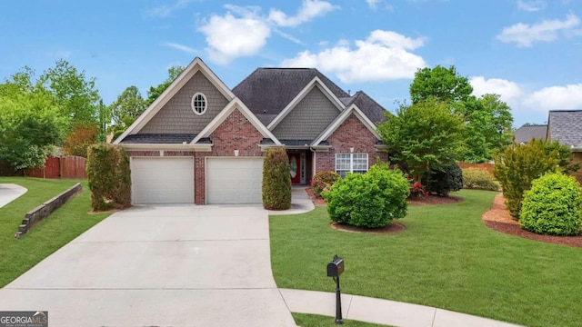 craftsman house with fence, a front yard, driveway, and brick siding